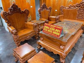 Ván ghế dày dặn sử dụng nguyên tấm gỗ hương đá 10 phân với hoa vân độc đáo, tay ghế cuộn tròn chà bóng mịn không chắp ghép