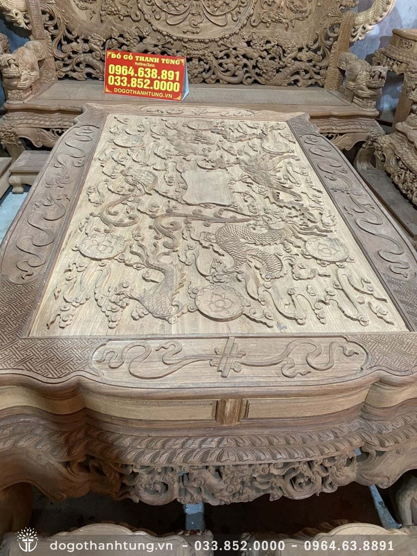 Mặt bàn đục nổi tranh tứ linh: Long - Lân - Quy - Phụng vờn mầy trên tấm gỗ nguyên khối, nét chạm tinh xảo. Khung tranh đục full họa tiết dày 4 phân.